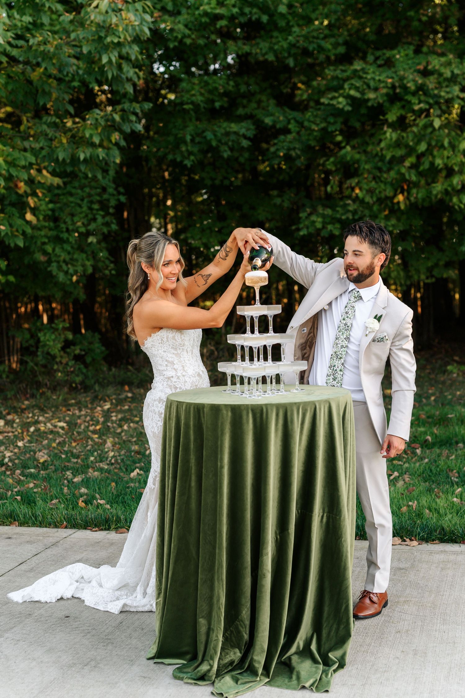 A classic black and white photo of newlyweds ascending grand outdoor stairs with white columns.