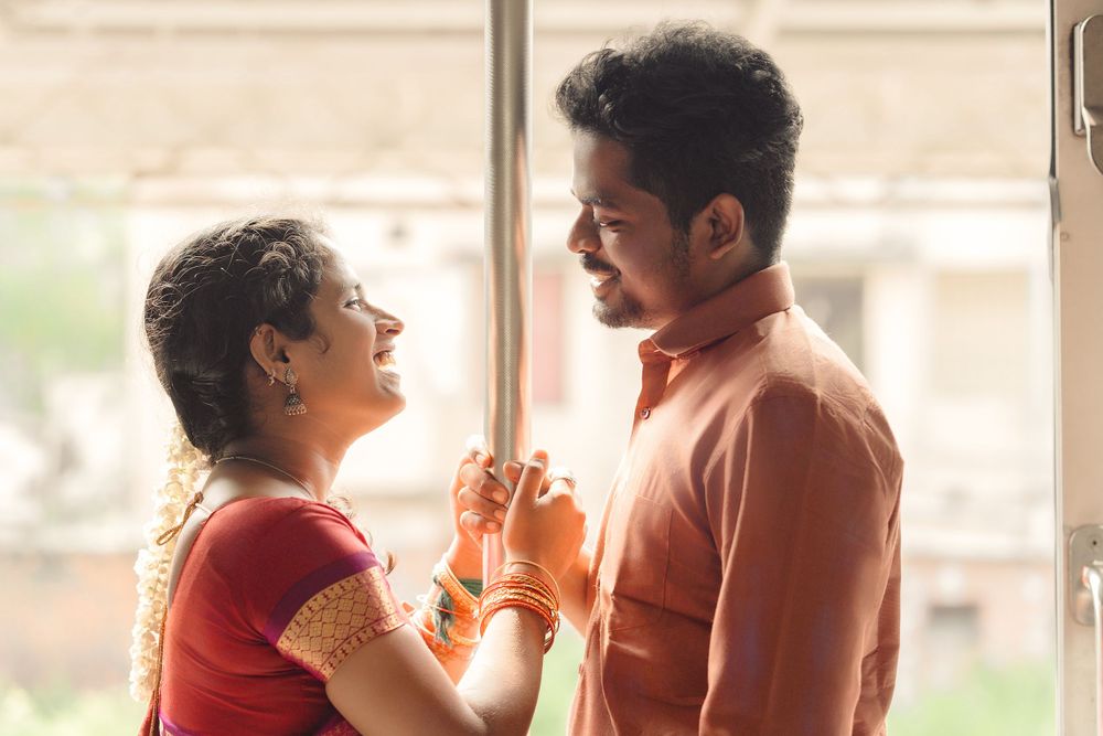 Romantic couple in traditional Indian clothing share an intimate moment near a window.