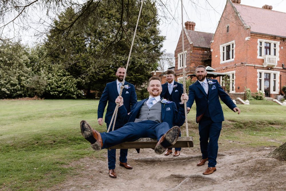 Groom and groomsmen men on swing Highley Manor