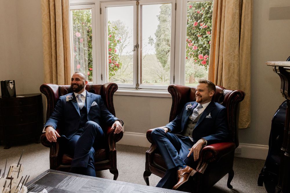 Groomsmen relaxing in armchairs at Highley manor