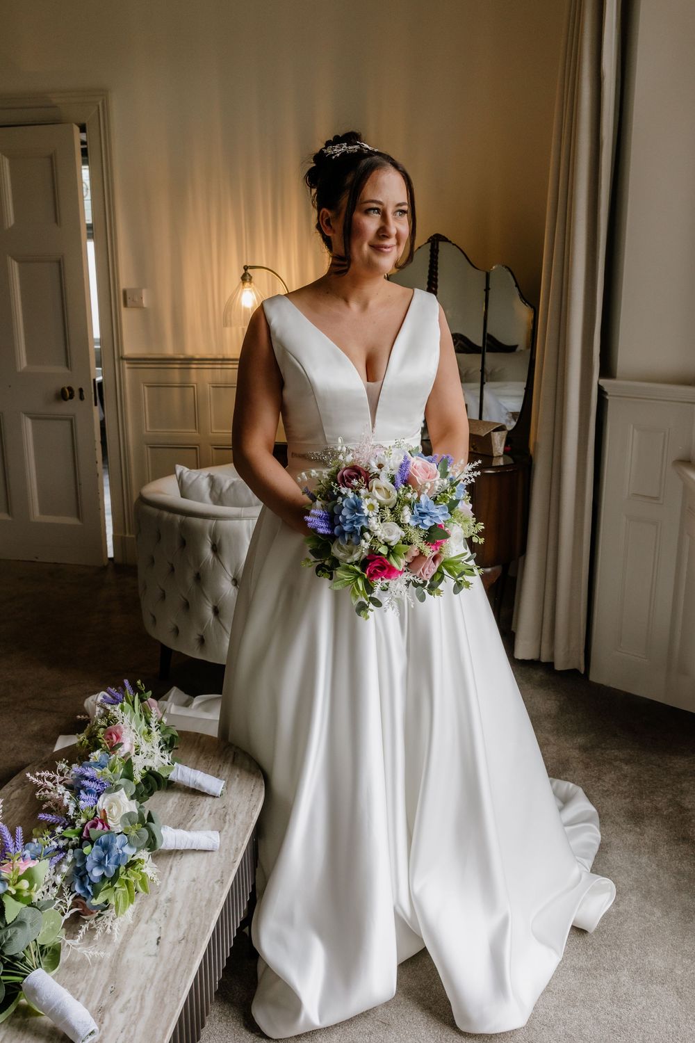 Bride with bouquet in bridal suite at Highley Manor