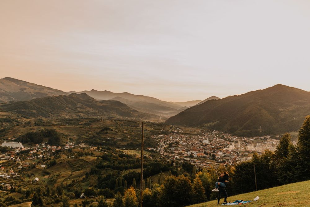 Golden hour panoramic view of a mountain valley town with autumn trees.