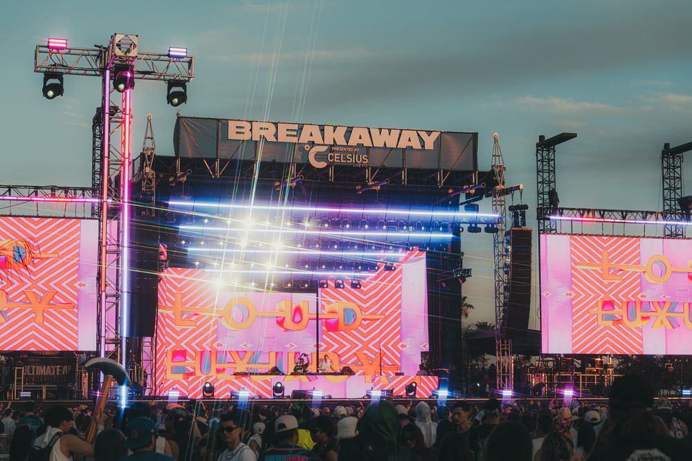Breakaway Music Festival stage lit with colorful LED displays and crowd gathered at outdoor concert event.