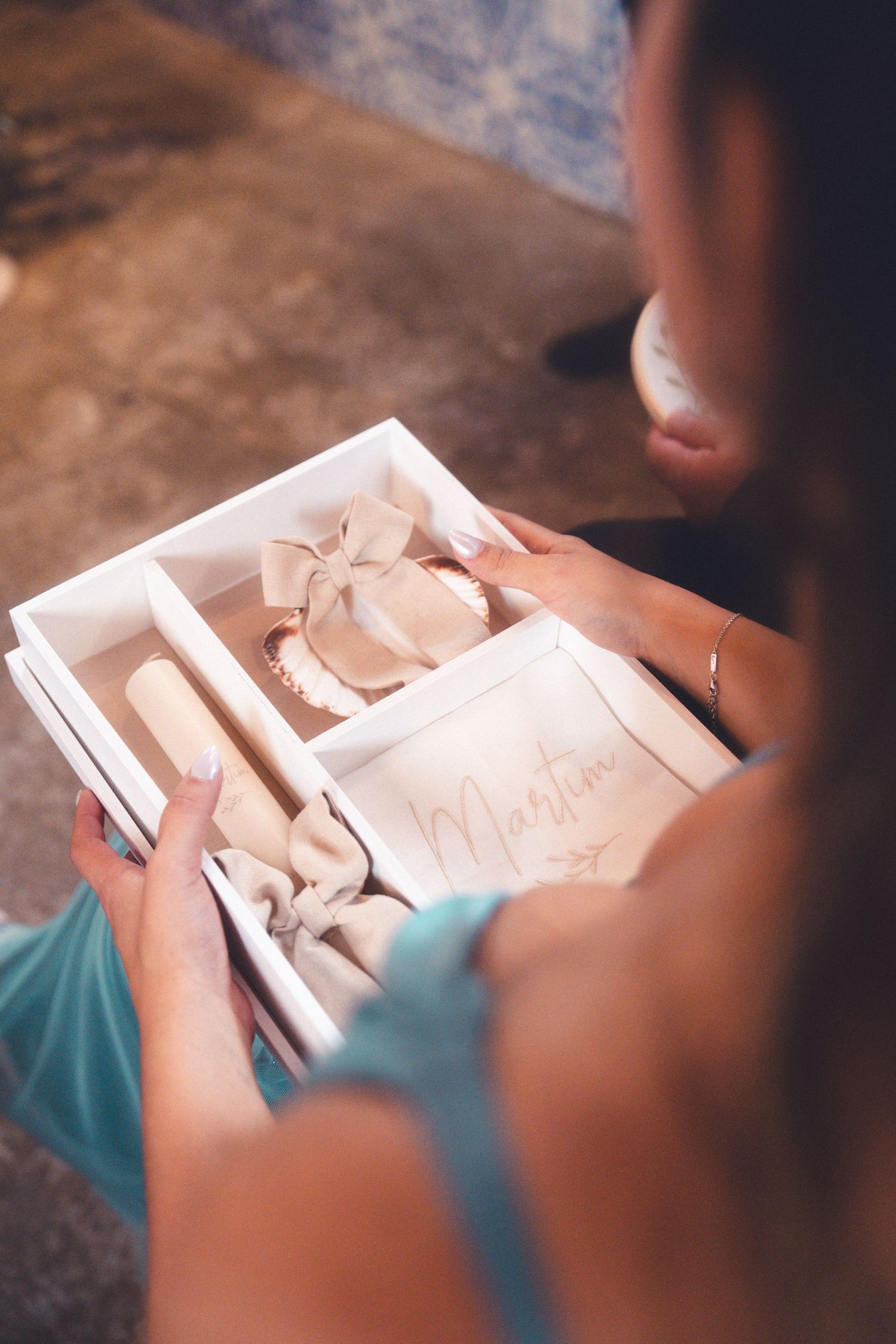 Hands holding and examining a decorative wooden box with intricate details.