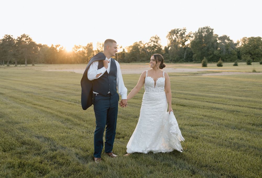 Golden hour wedding photo of bride and groom in field, taken by Ellie Rae Photography in La Crosse, Wisconsin