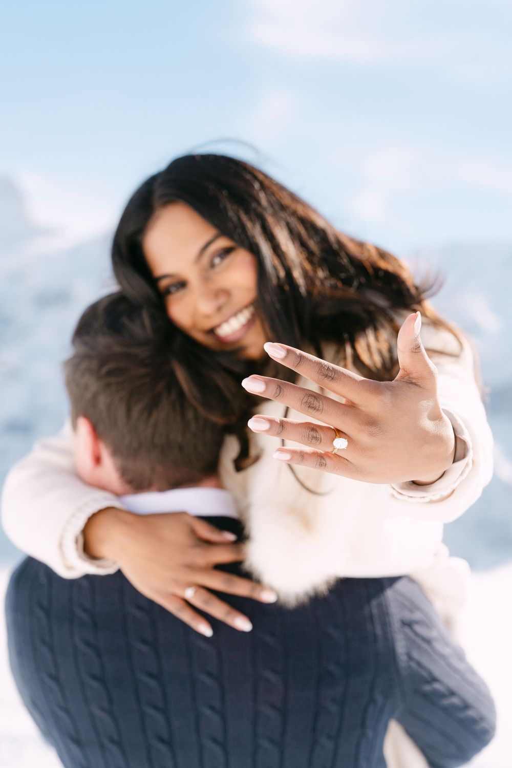 A series of four connected photos showing a couple embracing in a tender moment against a bright background.