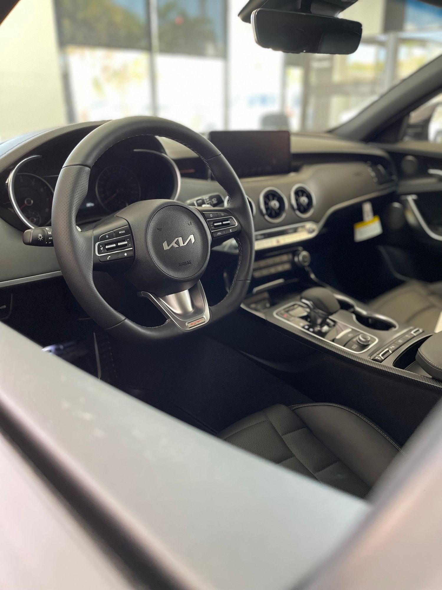 Interior view of a modern vehicle dashboard and steering wheel with digital displays.