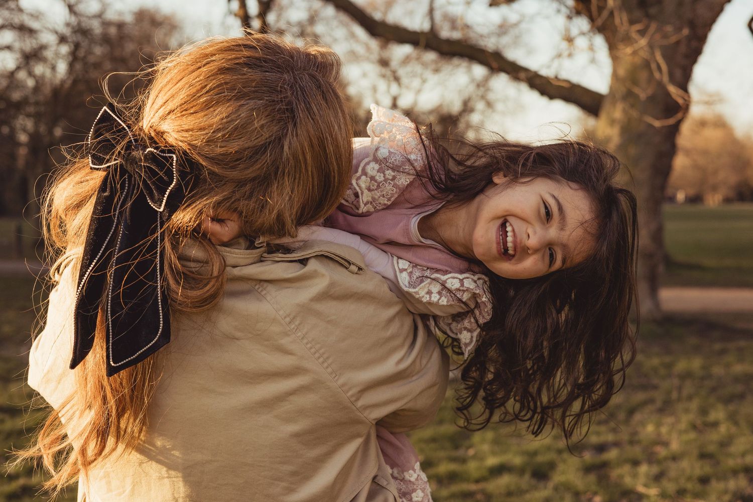 mum and daughter spinning around and laughing