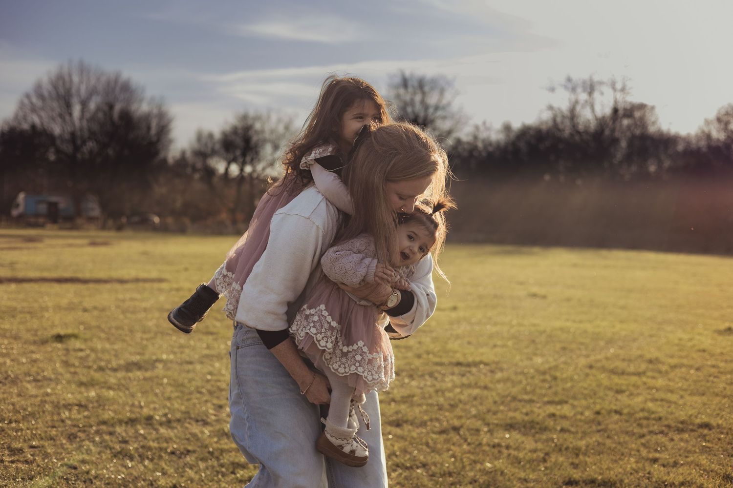 mum carries two children outdoors