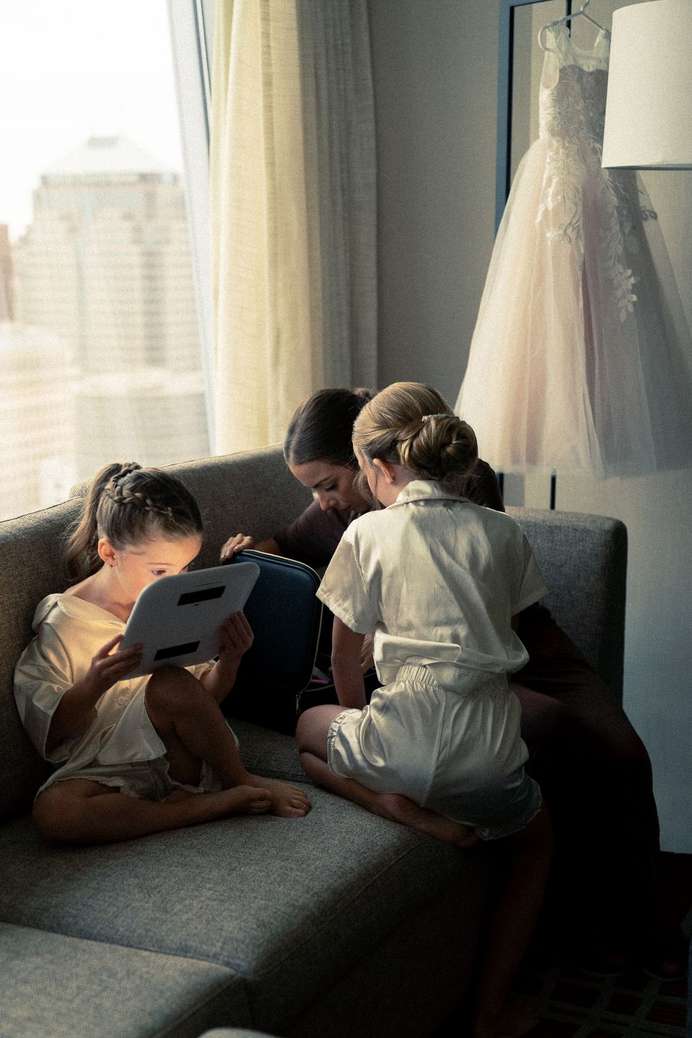 A sequence of candid photos showing people lounging and relaxing on a gray couch near a window with natural light.
