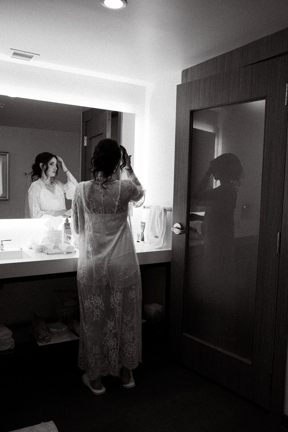 A series of black and white photographs showing figures in a dimly lit hallway or interior space.
