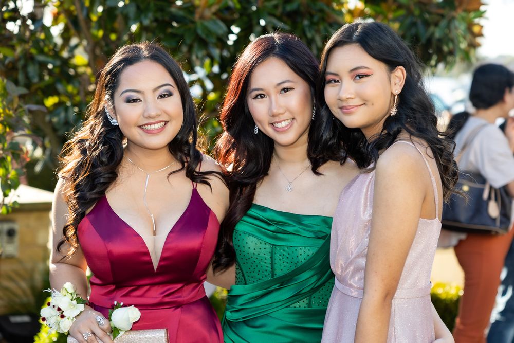 Sydney Event Photography - Three friends in elegant evening dresses posing together at an outdoor event.