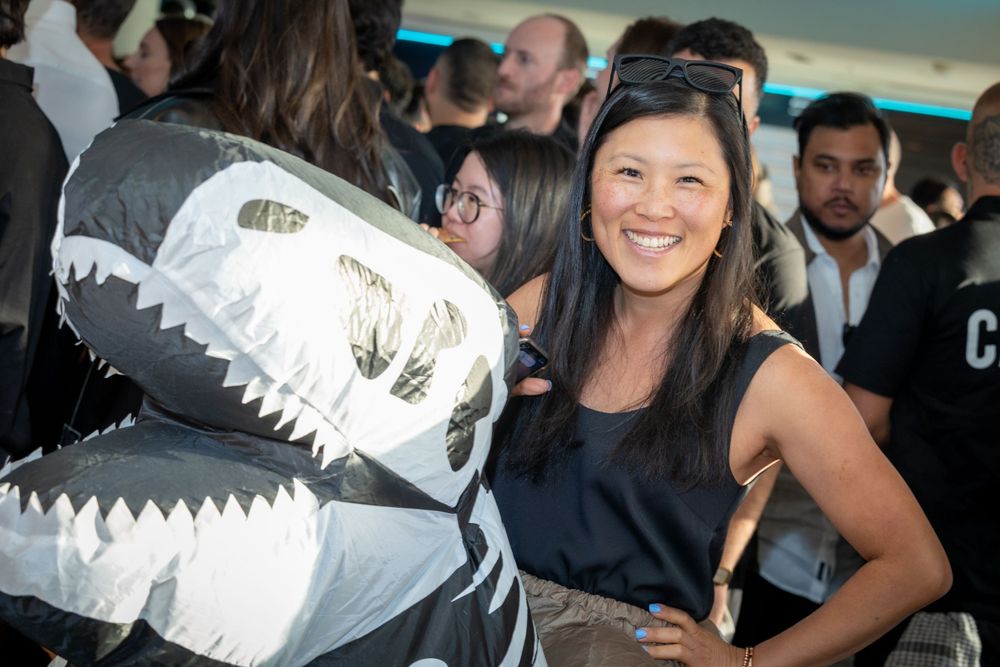 Sydney Event Photography - Person in dinosaur costume poses with party guest at social event.