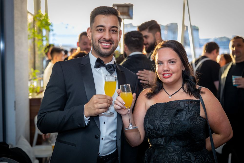 Sydney Event Photography - Formally dressed couple enjoys drinks at an elegant evening celebration.