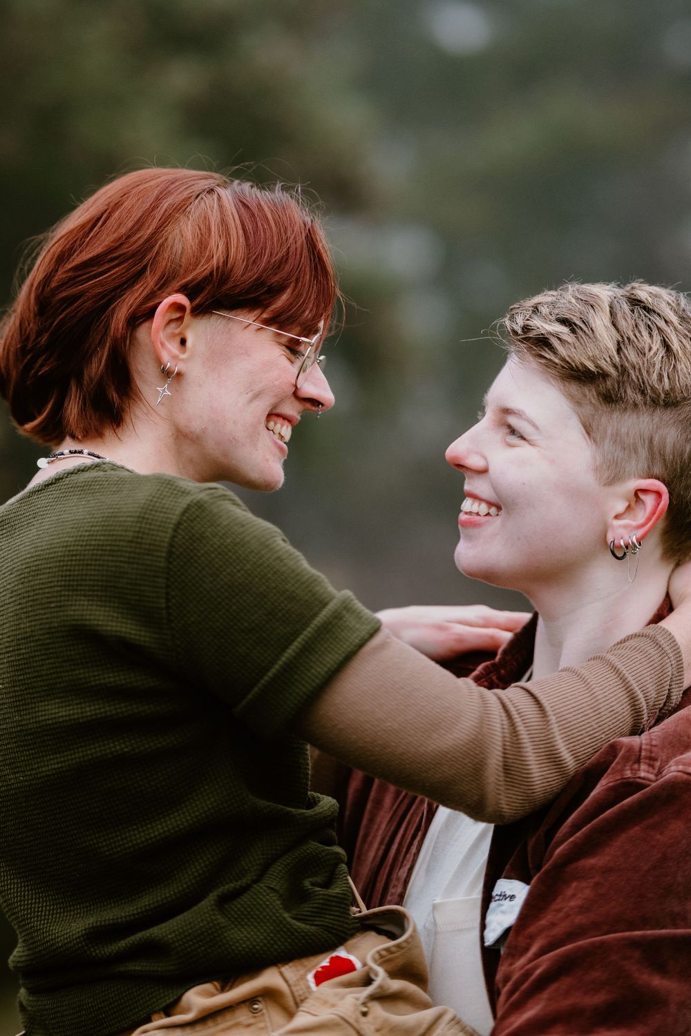 Candid outdoor portrait capturing genuine smiles and connection between two people.