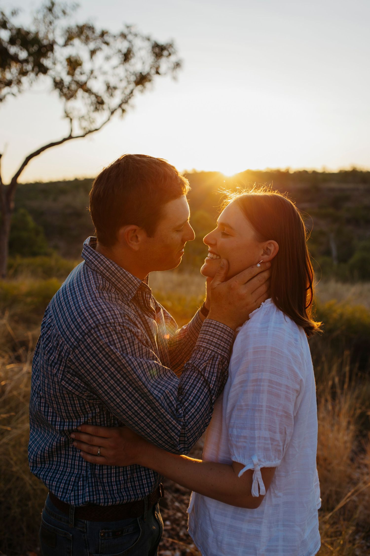 couple kissing during engagement photoshoot