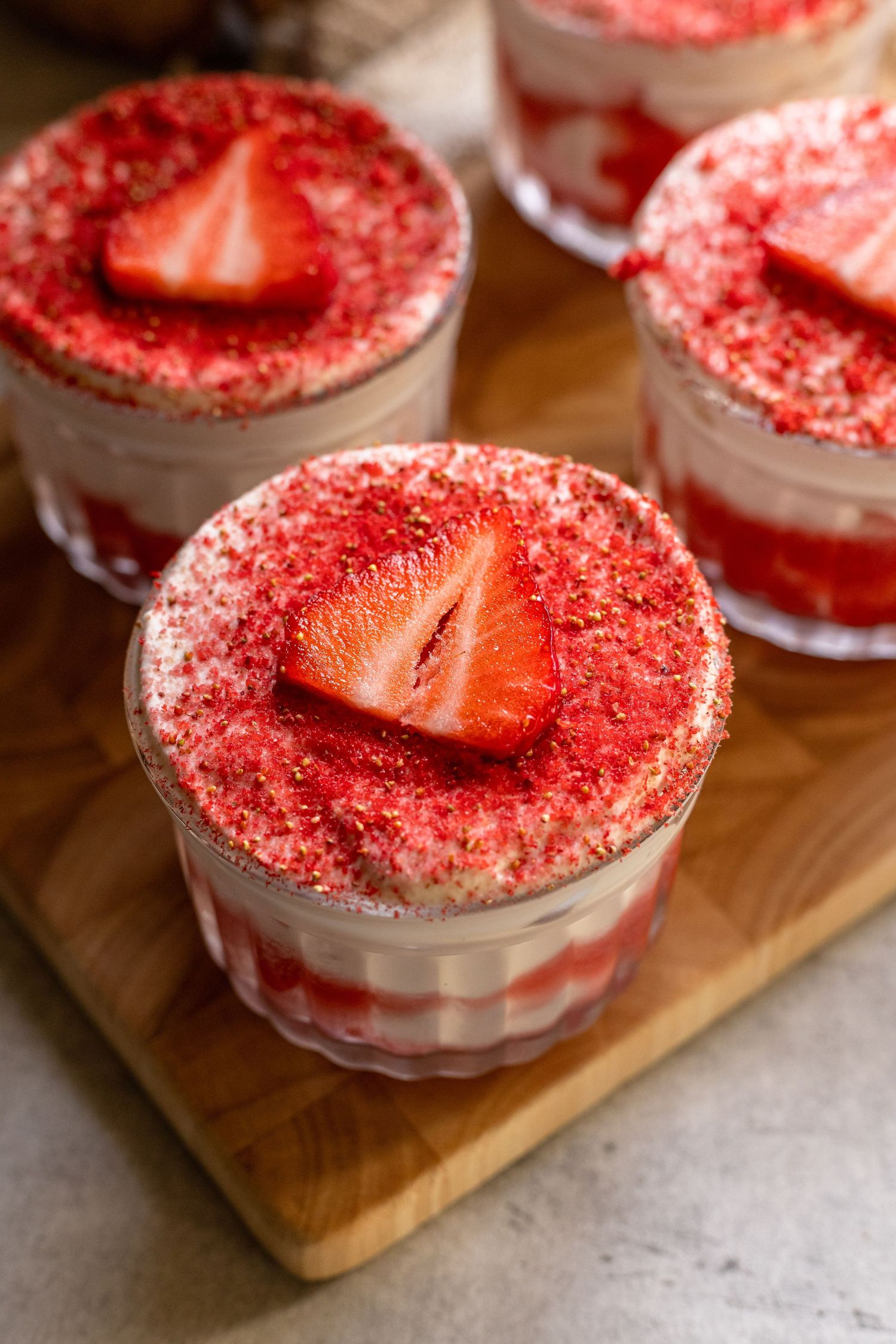 Close-up of chocolate mousse desserts in glass bowls with smooth and textured surfaces.