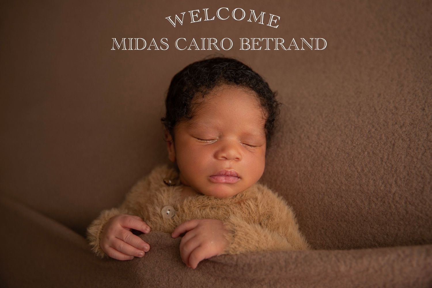 Newborn baby Midas Cairo Betrand sleeping peacefully on a brown fuzzy blanket in a professional welcome photo.