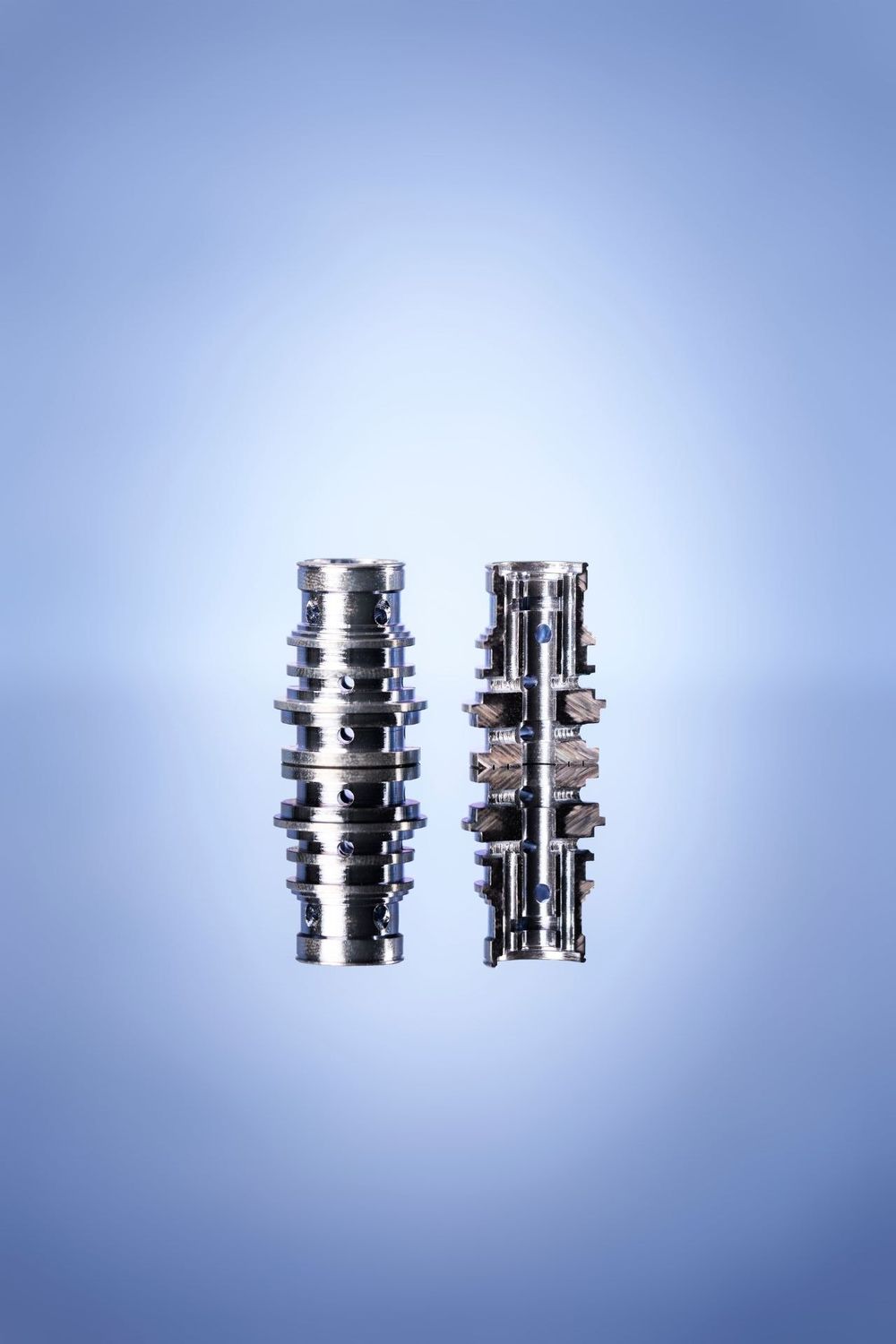 Chrome mechanical components displayed in sequence showing progressive size reduction against blue background.