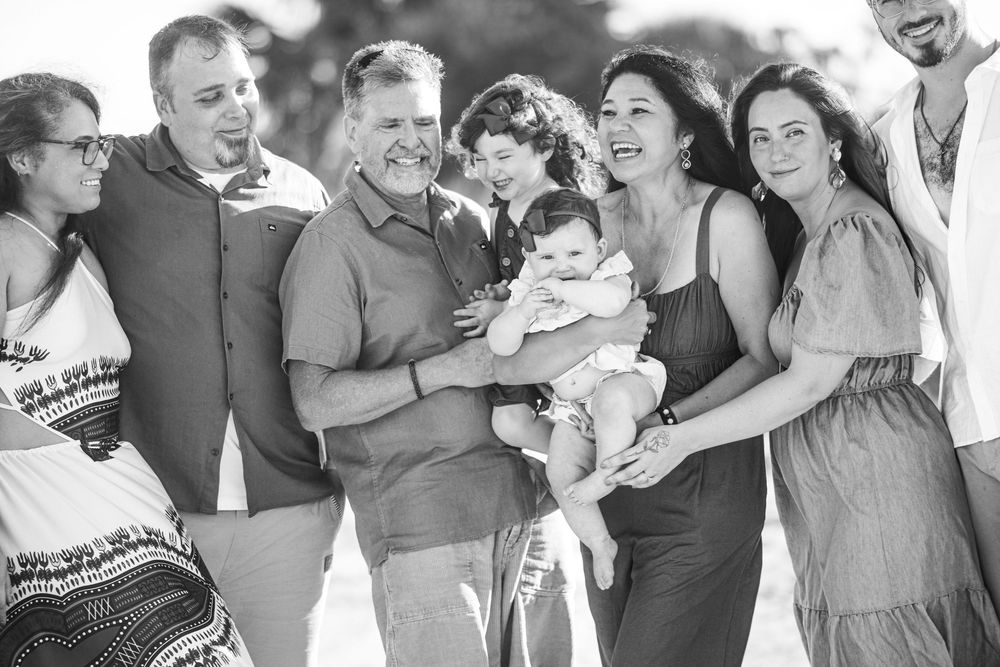 Black and white candid group photo showing joyful expressions and laughter.