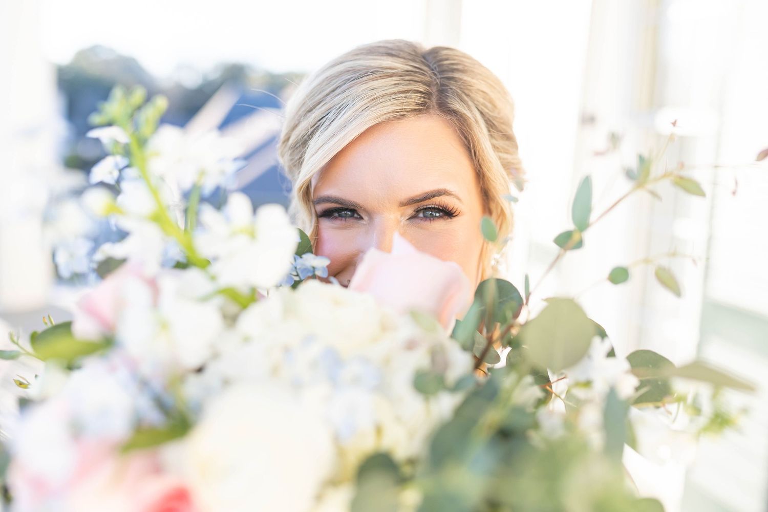 bride behind bouquet