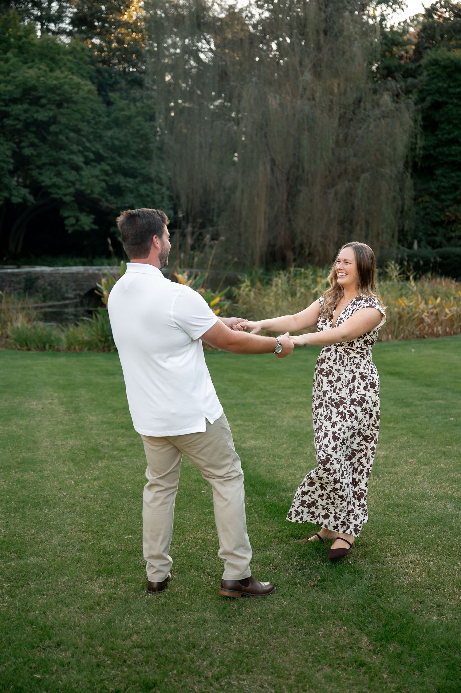 Playful dancing sequence in a grassy field during golden hour.