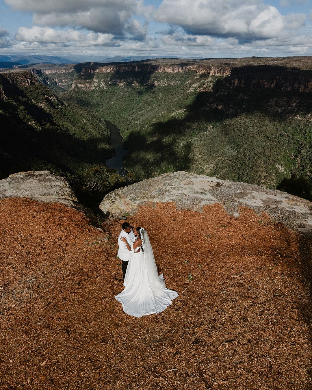 A series of panoramic landscape shots of rugged canyon cliffs transitions to a figure in white on red desert terrain.