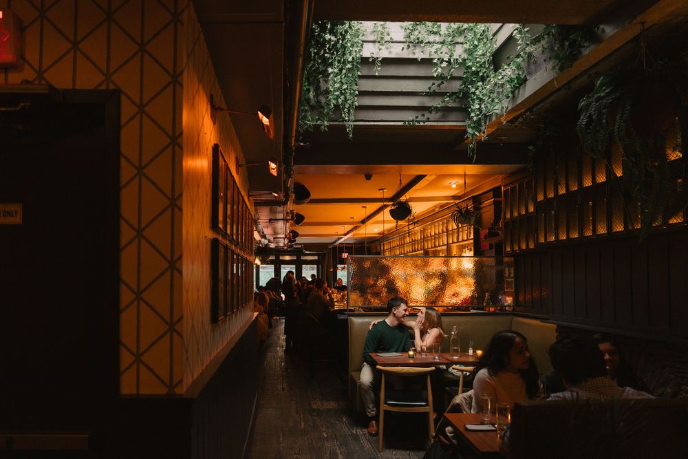 Moody indoor scene with warm lighting and geometric patterns creating dramatic atmosphere.