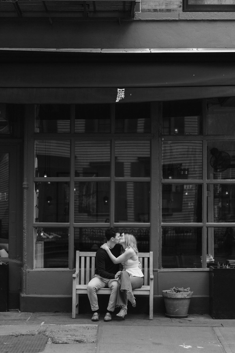 Black and white sequence of a proposal moment outside a storefront.