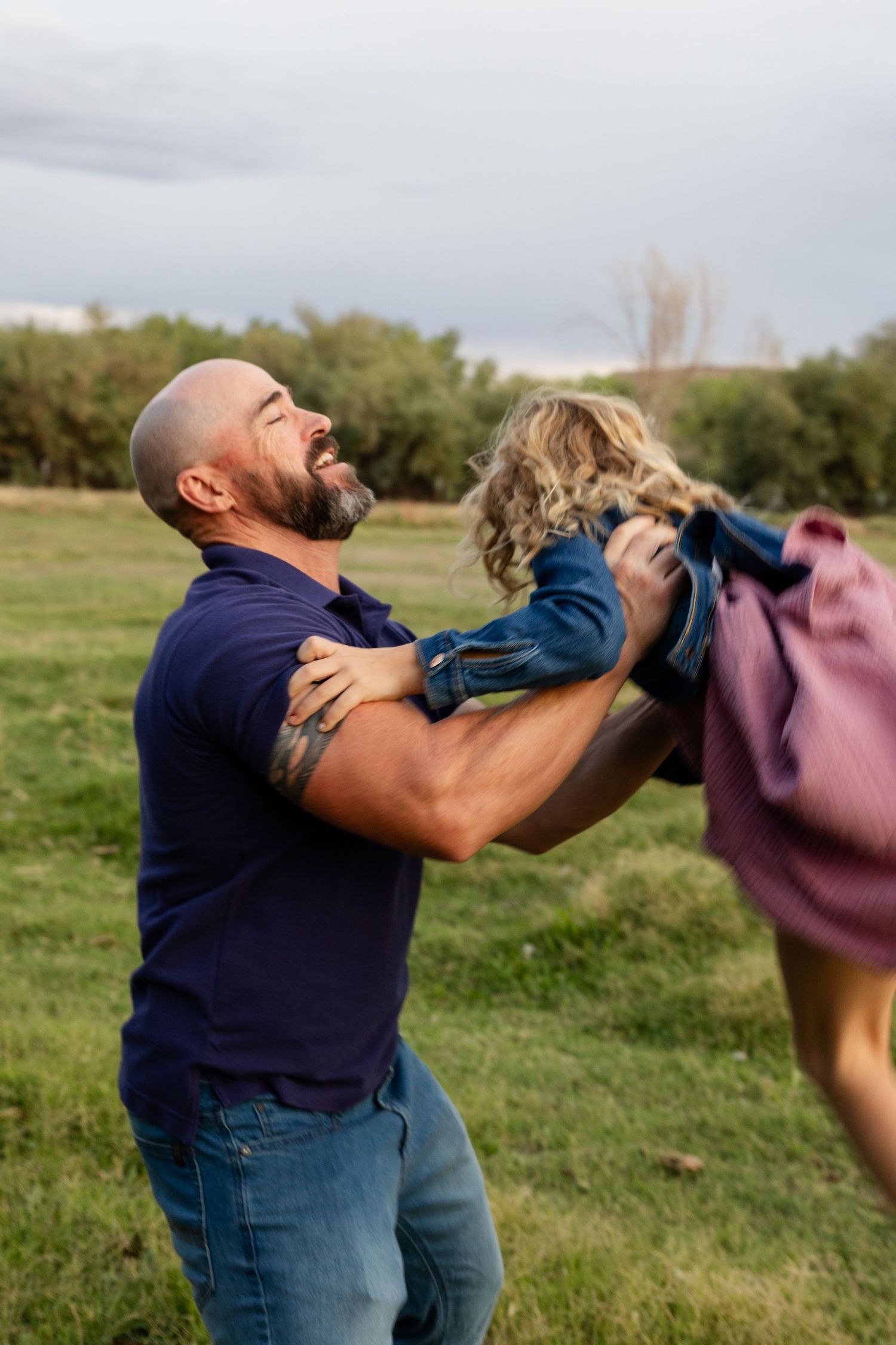 dad throwing 10 year old daughter in the air