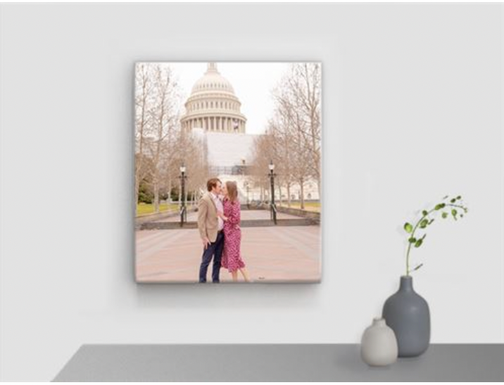 Family photography canvas print, displayed in a home setting above a table and small vases