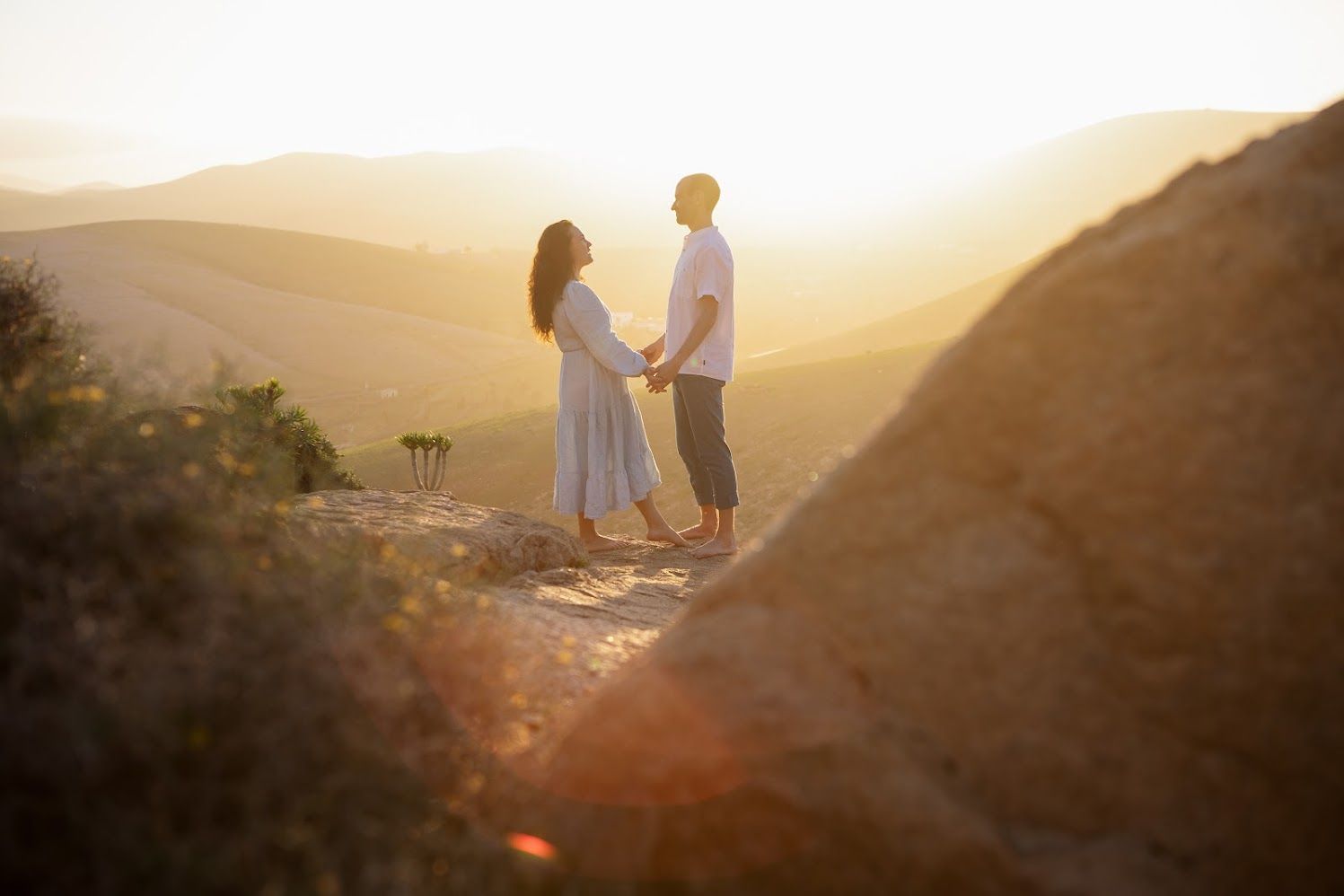 Close-up of a bride and groom holding hands, showing the detail of their wedding attire - Minimalist wedding photography in Lanzarote