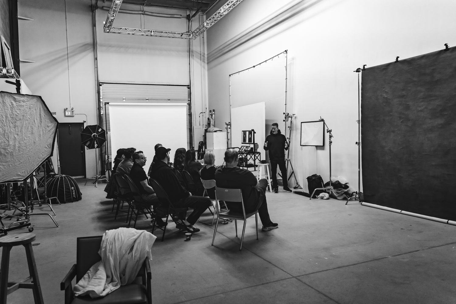 Empty industrial warehouse interior with white walls and concrete floors showing multiple connected spaces.