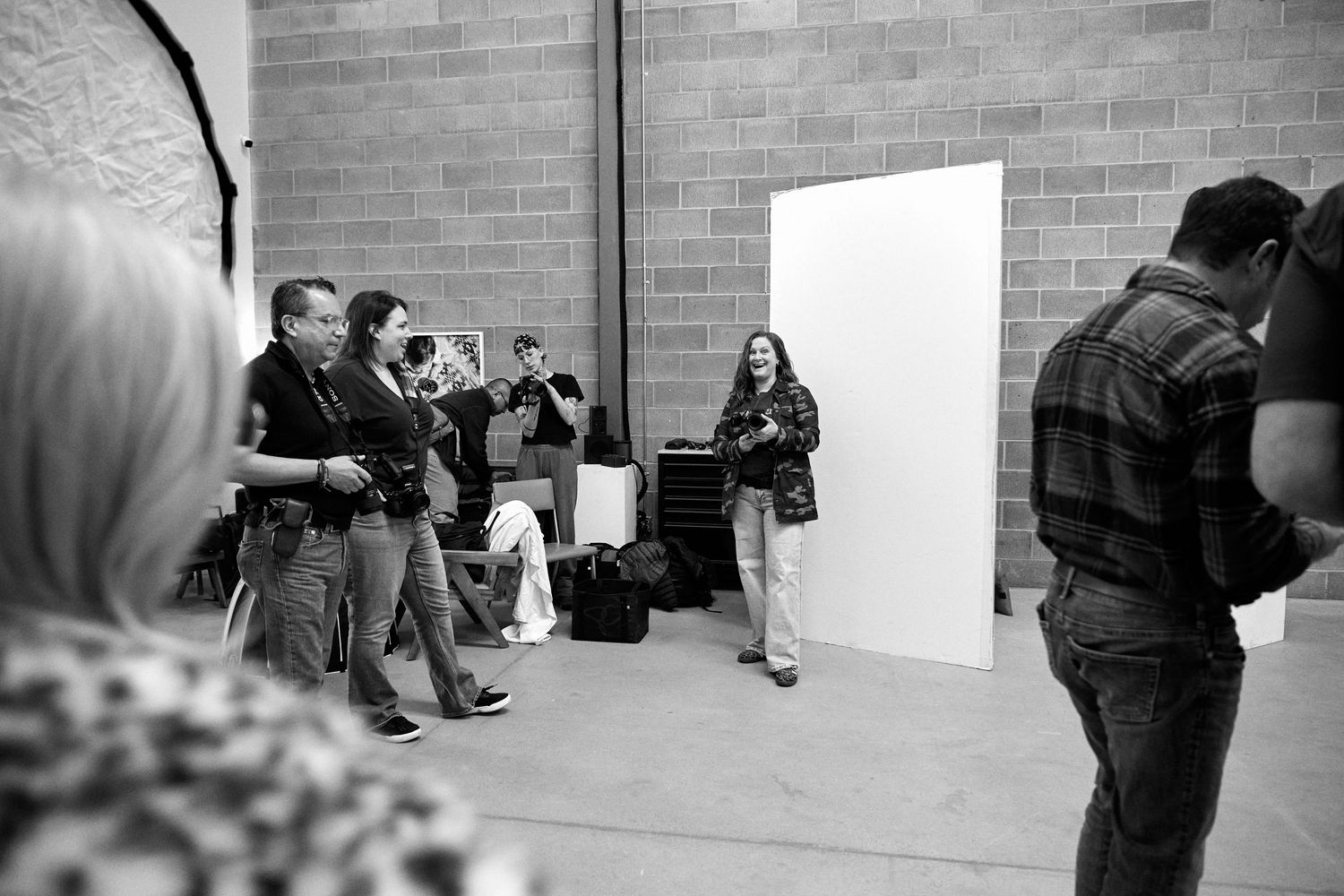 A sequence of black and white photos showing a person leaning against a brick wall in various poses.