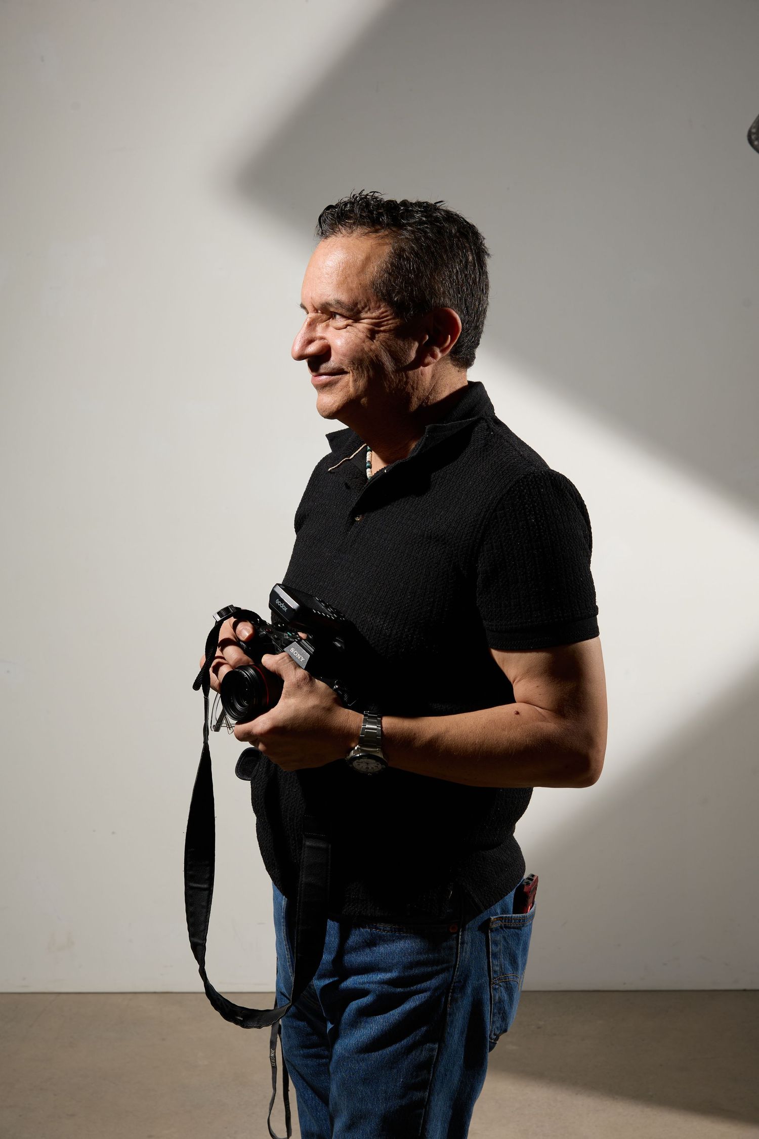 Series of dramatic studio portraits with strong side lighting against a white background.