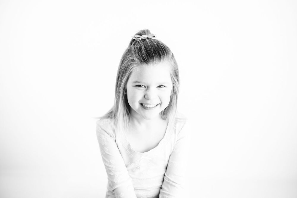 A series of black and white portrait photographs showing different poses and expressions.