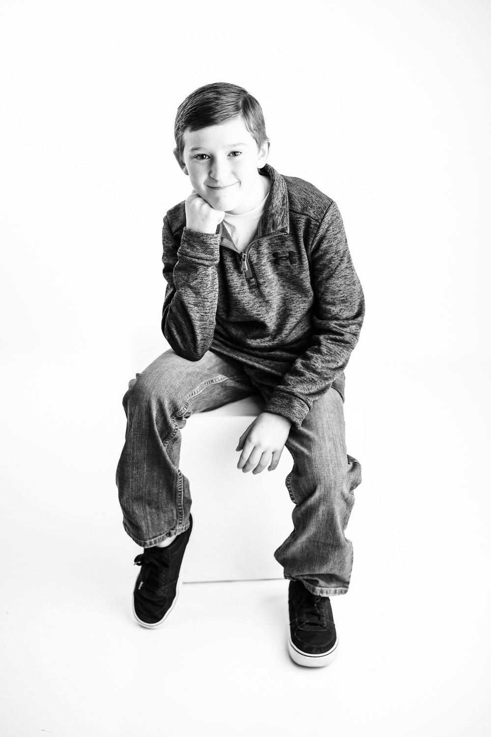 Black and white artistic photo series showing a person crouching in four similar poses against a white background.