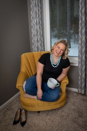 Lifestyle portraits showing relaxed poses in a mustard yellow armchair with decorative curtains and carpet.