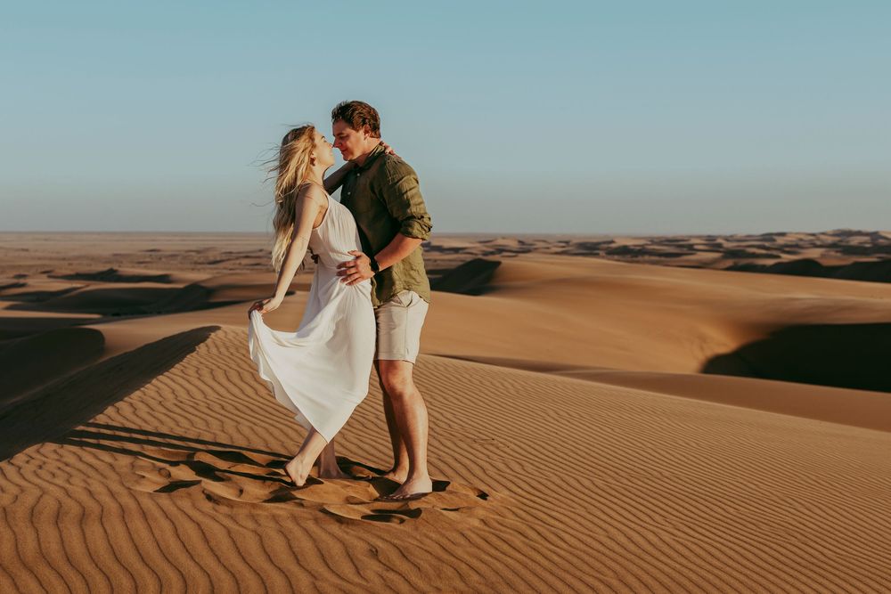 Couple captured during photoshoot on Swakopmund dunes at sunset