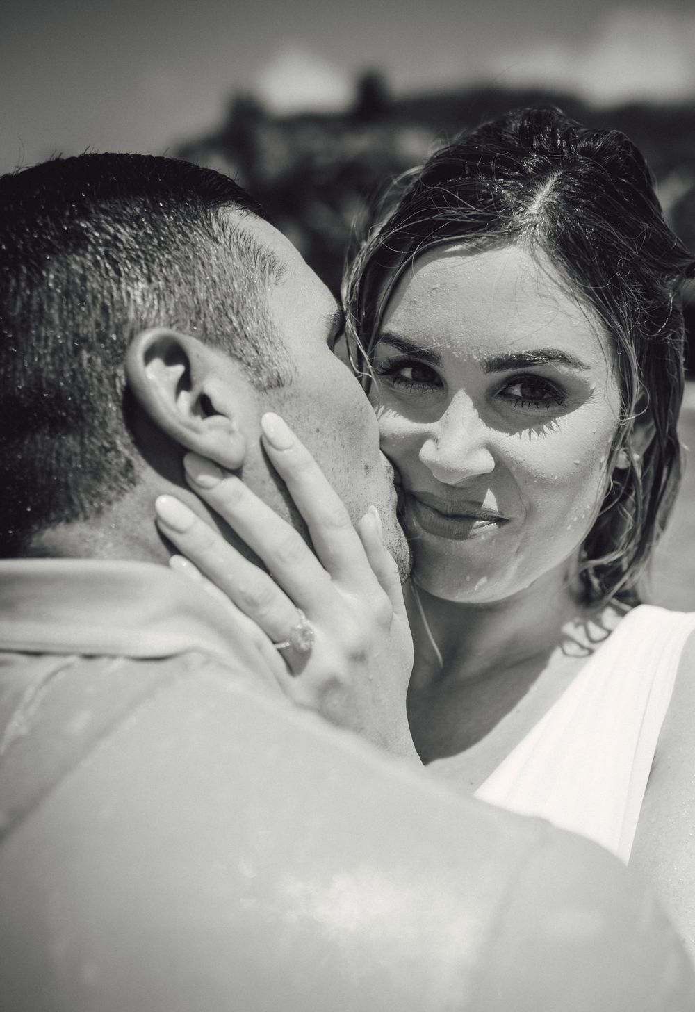 Romantic black and white photo sequence showing a couple sharing an intimate kiss while wearing sunglasses.