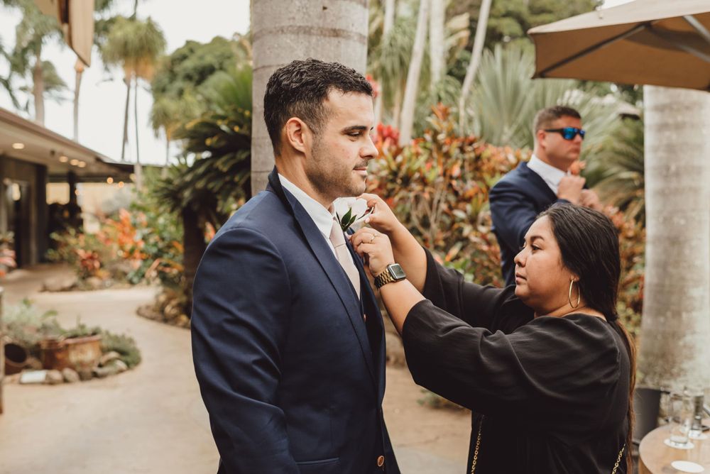 Candid outdoor wedding moments captured between couples at a tropical palm tree venue.