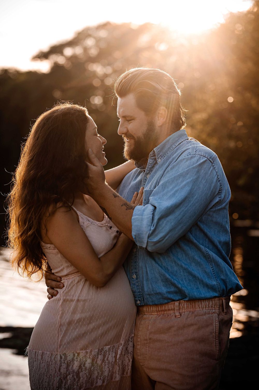 Sunset photoshoot with warm backlighting creating a romantic silhouette against golden hour light.