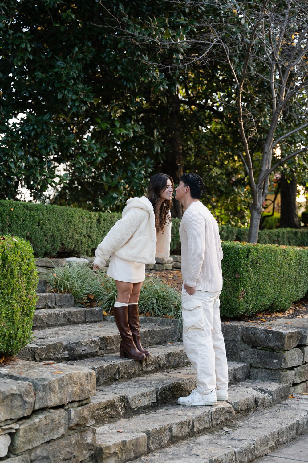 Luxury engagement proposal at Dallas Arboretum with couple smiling and hugging