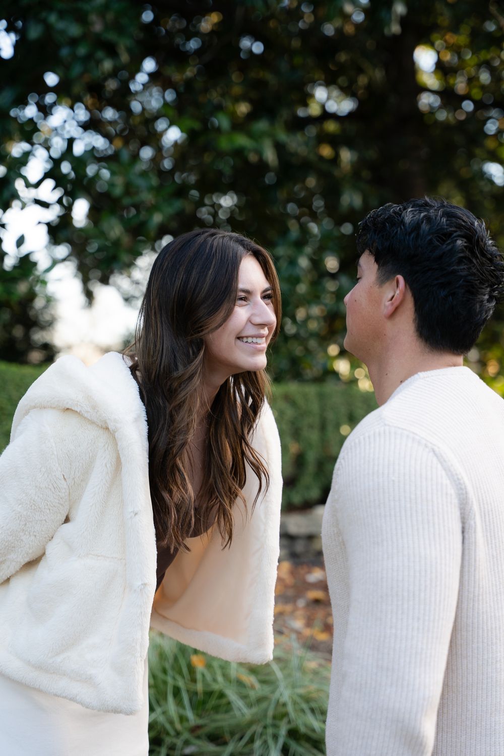 Luxury engagement proposal at Dallas Arboretum with couple smiling and hugging