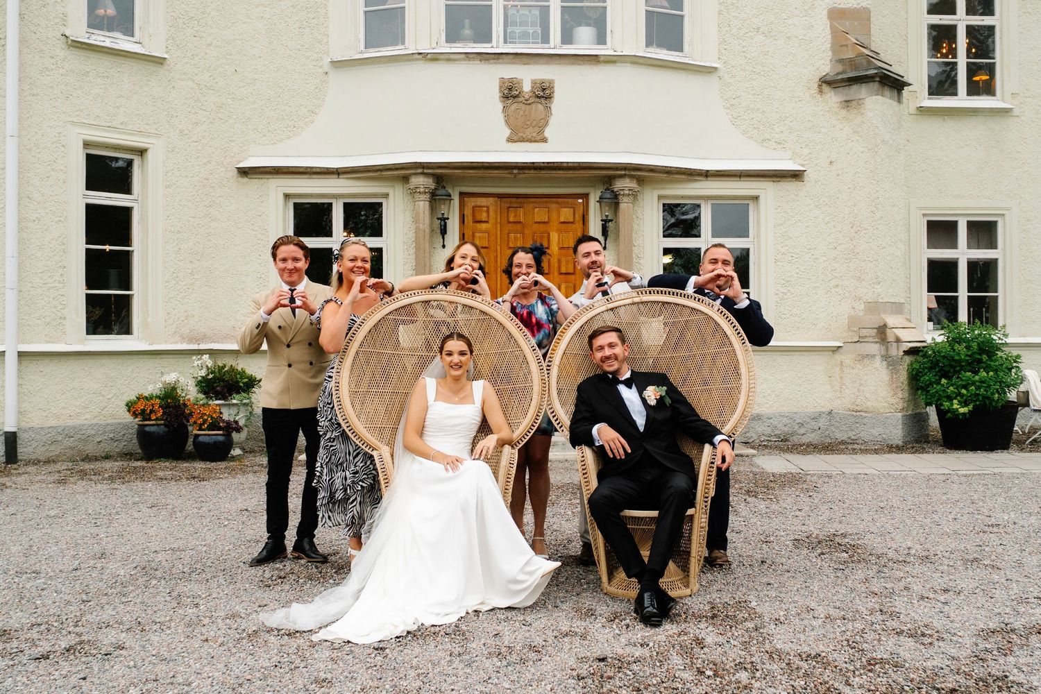 Married couple sat with group posing enjoying photo roulette together at Southdowns manor