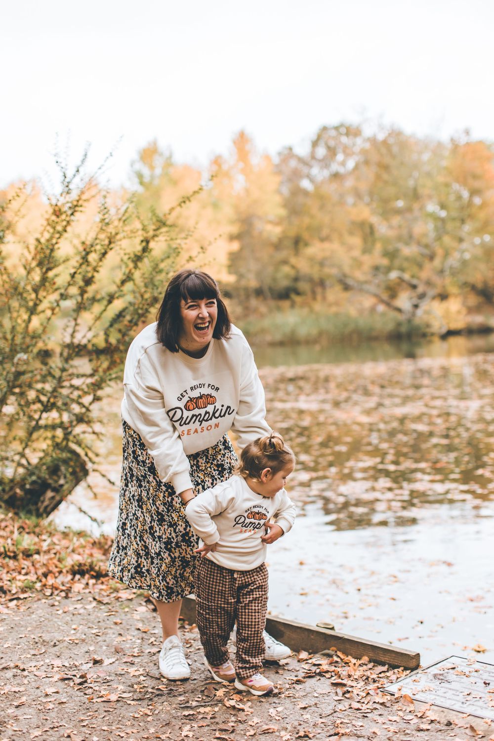 A series of candid moments captured by a lake with fallen leaves and autumn scenery.