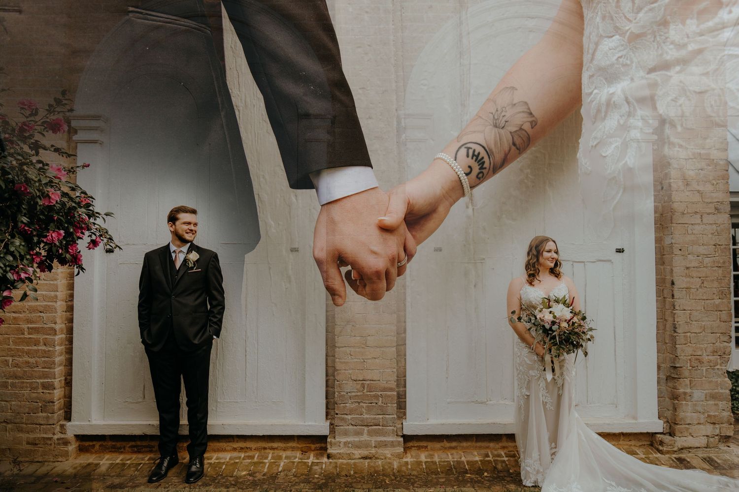Elegant wedding couple holding hands while walking through a rustic brick venue with natural light streaming in.