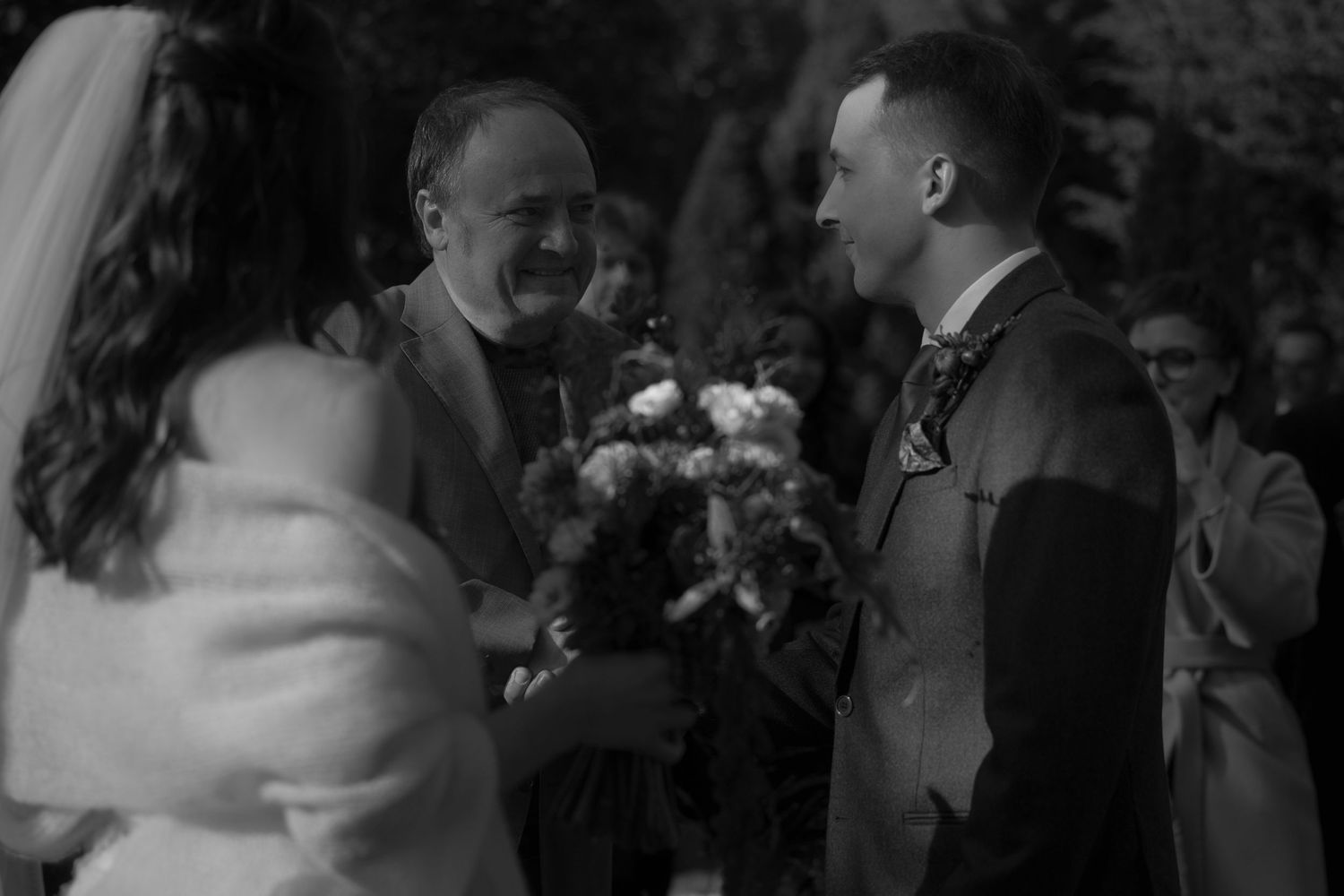 A series of black and white wedding photos showing candid moments during a reception celebration.