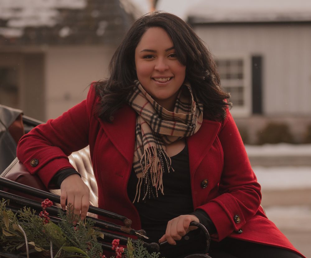 A person in a red coat and plaid scarf poses outdoors in a series of candid shots.