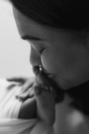 Artistic black and white profile silhouette showing gentle expression.